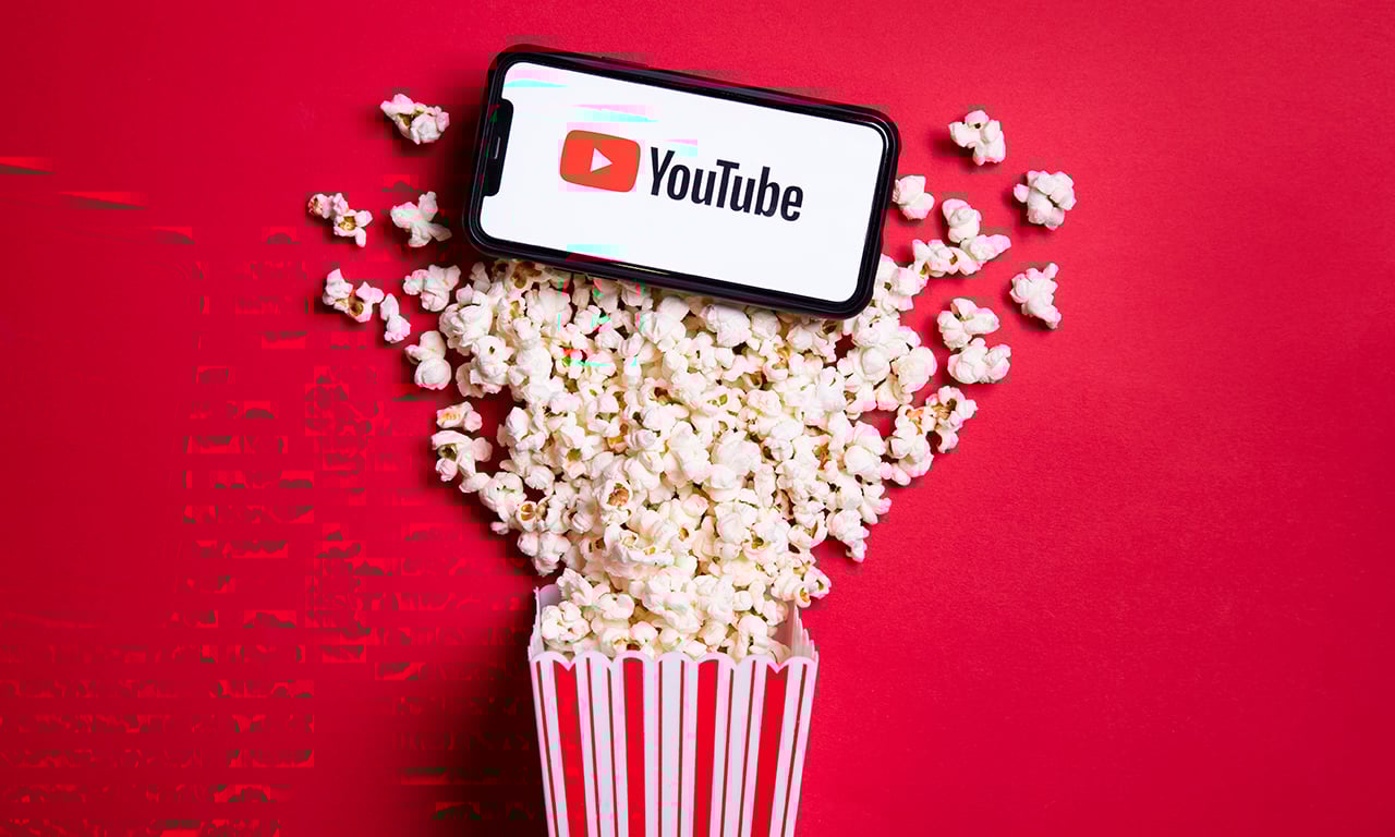 phone with youtube logo popping out of a popcorn box