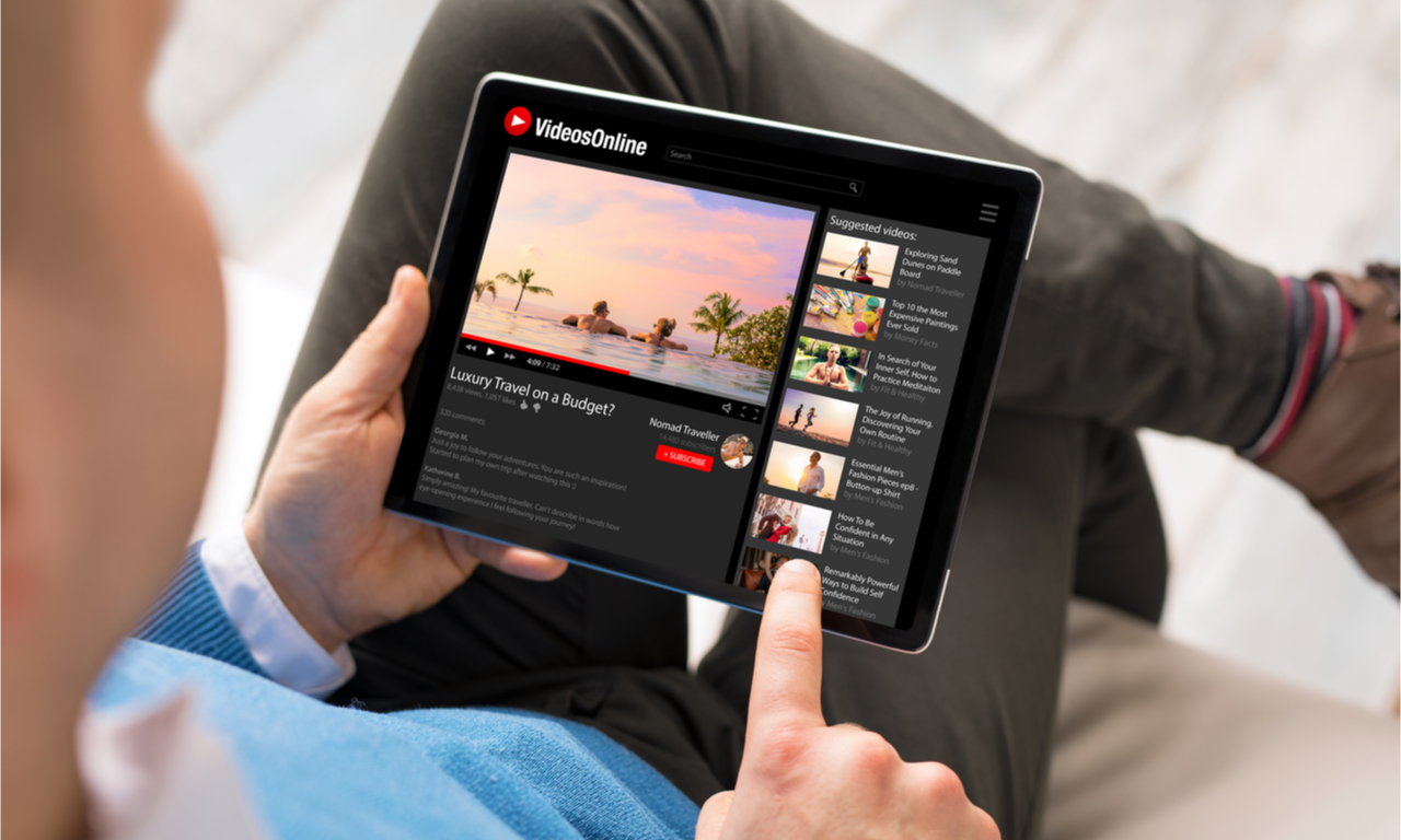 man browsing through youtube on his tablet device