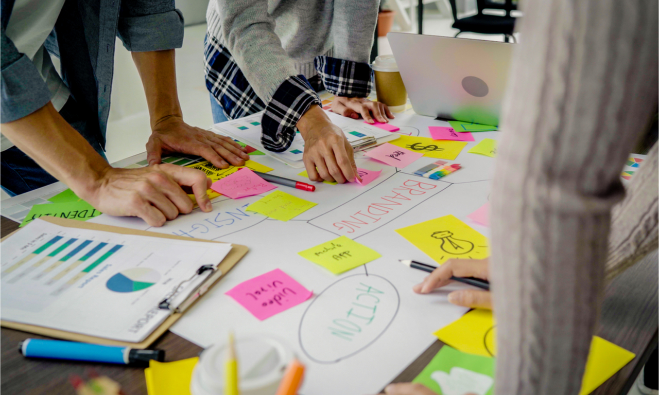 team working out a digital strategy with some paper and sticky notes