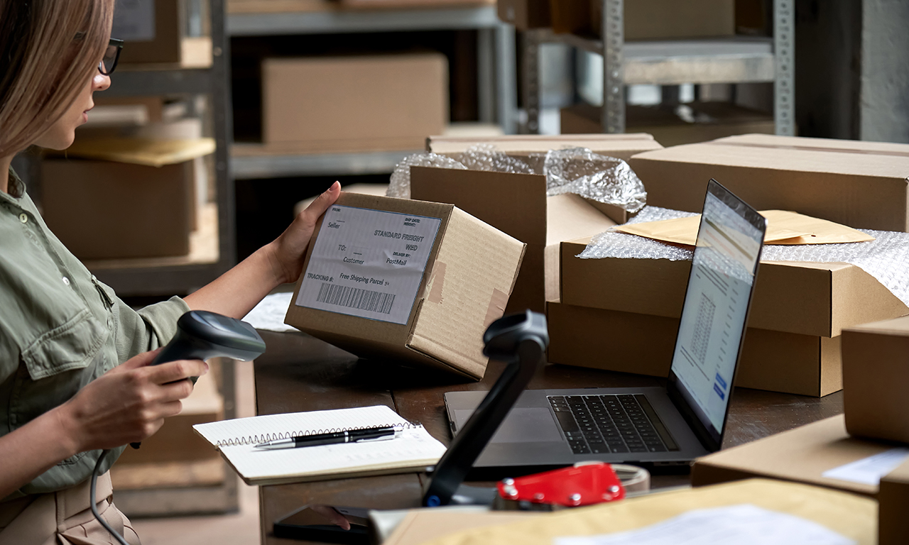 lady scanning ecommerce package in warehouse