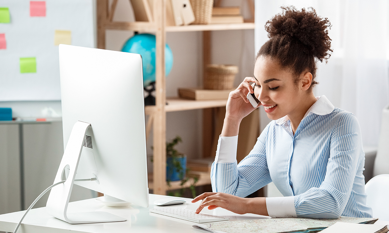 lady taking marketing call while working on computer