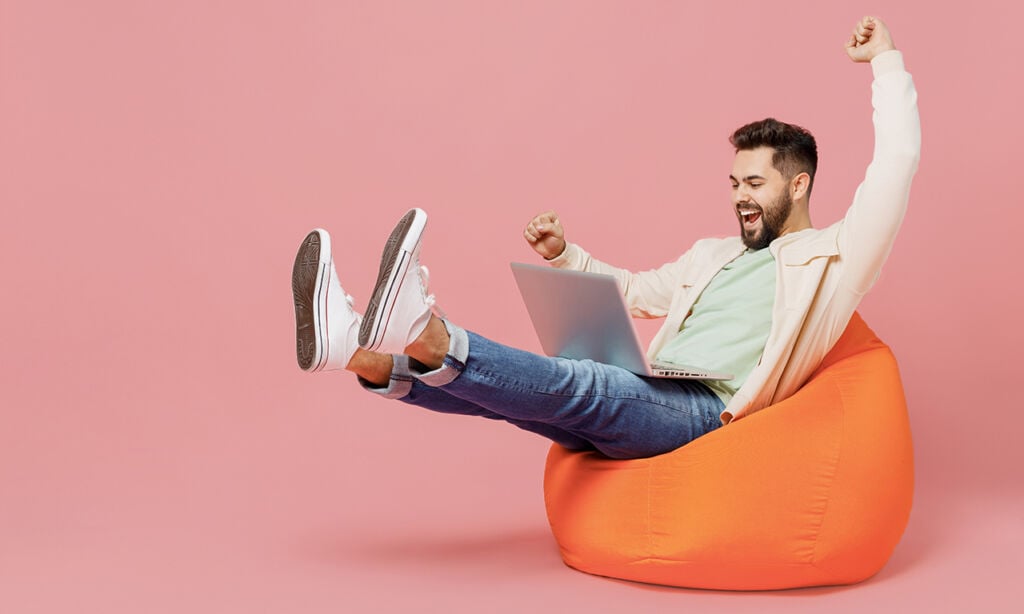 man on bean bag cheering about his digital marketing strategies